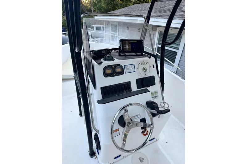 Slide: The Image of 2006 Century 2001 Center Console boat dashboard with steering wheel and navigation equipment. - 4
