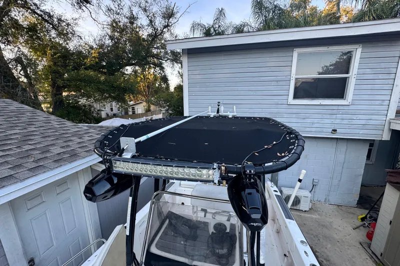 Slide: The Image of 2006 Century 2001 Center Console boat with rooftop view near residential buildings. - 6