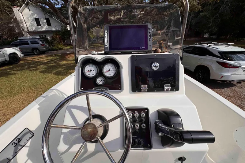 Slide: The Image of 2017 NauticStar 1810 NauticBay boat dashboard with steering wheel and navigation equipment. - 12