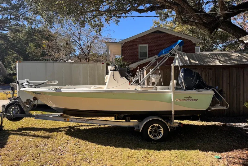 Slide: The Image of 2017 NauticStar 1810 NauticBay boat on trailer, parked outdoors. - 2