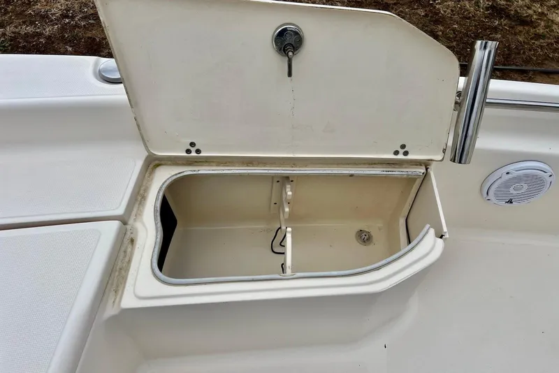 Slide: The Image of Open storage compartment on a 2009 Scout 240 Bay Scout boat deck. - 11