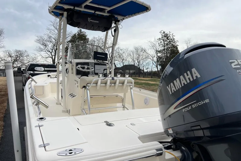 Slide: The Image of 2009 Scout 240 Bay Scout boat with Yamaha 250 four-stroke engine, parked outdoors. - 13
