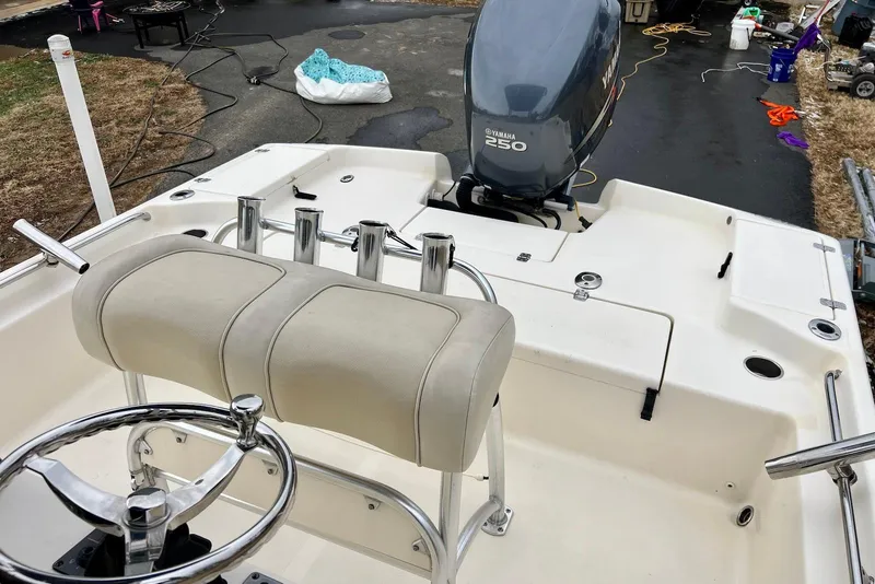 Slide: The Image of 2009 Scout 240 Bay Scout boat with Yamaha 250 engine, featuring a sleek helm and seating. - 16