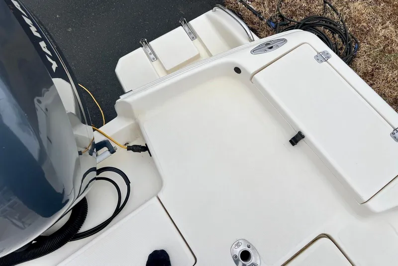 Slide: The Image of 2009 Scout 240 Bay Scout boat deck with Yamaha engine and storage compartments. - 17