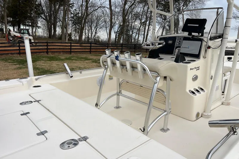 Slide: The Image of 2009 Scout 240 Bay Scout boat interior with steering console and rod holders. - 18