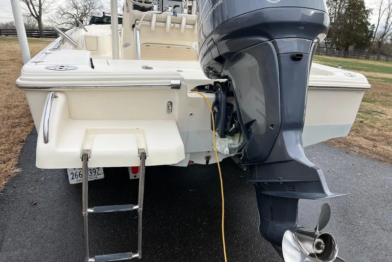 Slide: The Image of 2009 Scout 240 Bay Scout boat with outboard motor and swim ladder on a trailer. - 20
