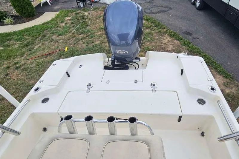 Slide: The Image of 2009 Scout 240 Bay Scout boat with Yamaha 250 engine, parked on grass. - 25