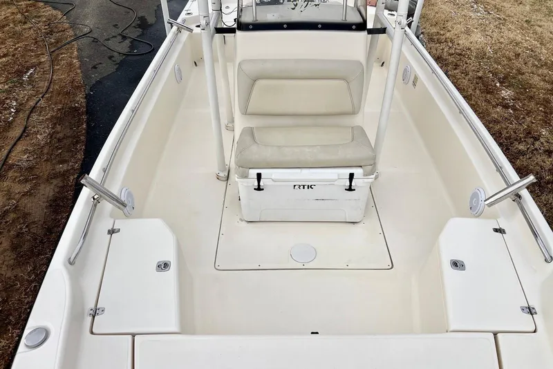 Slide: The Image of 2009 Scout 240 Bay Scout boat interior with seating and storage compartments. - 5