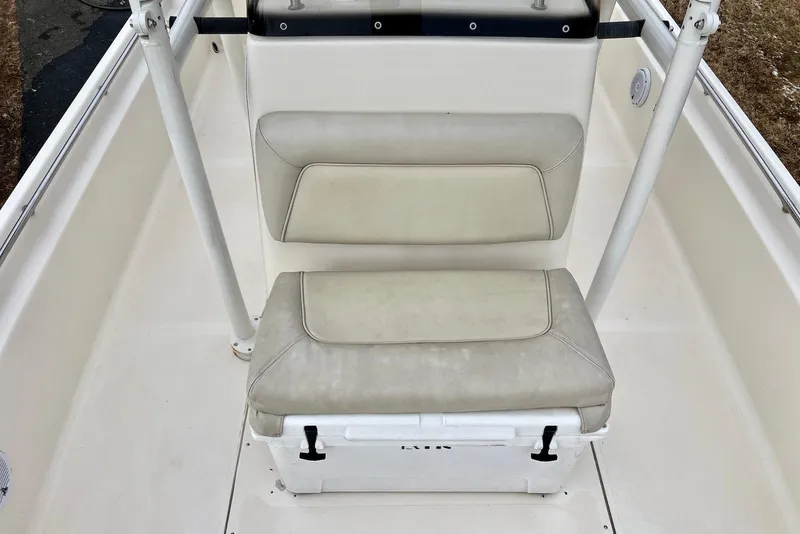 Slide: The Image of 2009 Scout 240 Bay Scout boat seating area with cushioned bench and storage. - 7