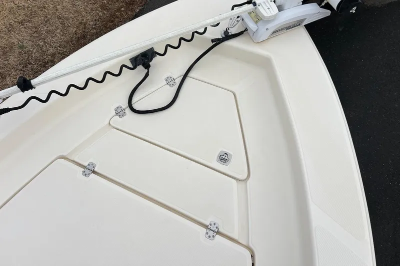 Slide: The Image of 2009 Scout 240 Bay Scout boat deck with storage compartments and trolling motor. - 9