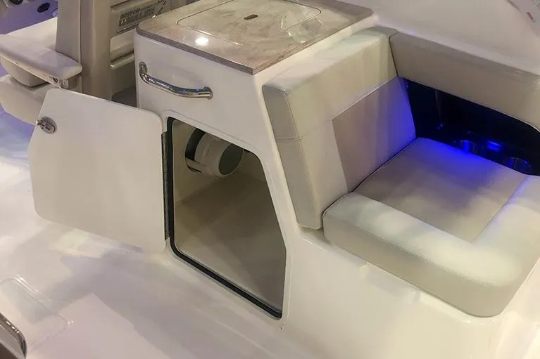 Slide: The Image of Manufacturer Provided Image: 2026 Boston Whaler 280 Vantage interior with open storage compartment and cushioned seating. - 10