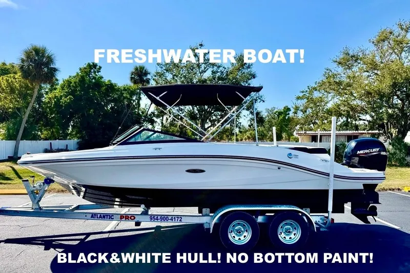 The Image of 2023 Sea Ray SPX 210 Outboard boat with black and white hull on a trailer. - 0