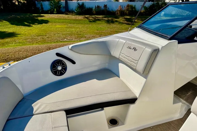 Slide: The Image of 2023 Sea Ray SPX 210 Outboard boat interior with cushioned seating and speaker. - 10