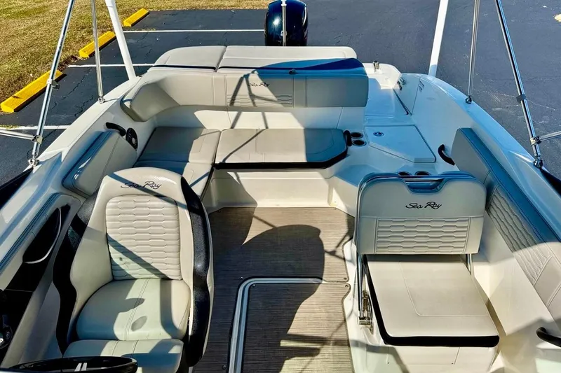 Slide: The Image of 2023 Sea Ray SPX 210 Outboard boat interior with seating and steering wheel. - 12