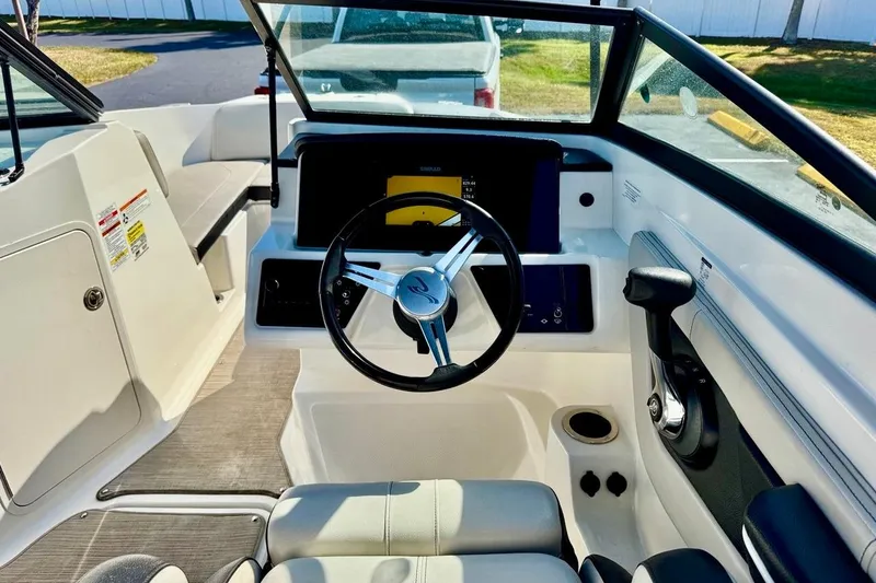 Slide: The Image of 2023 Sea Ray SPX 210 Outboard boat interior with steering wheel and dashboard. - 13