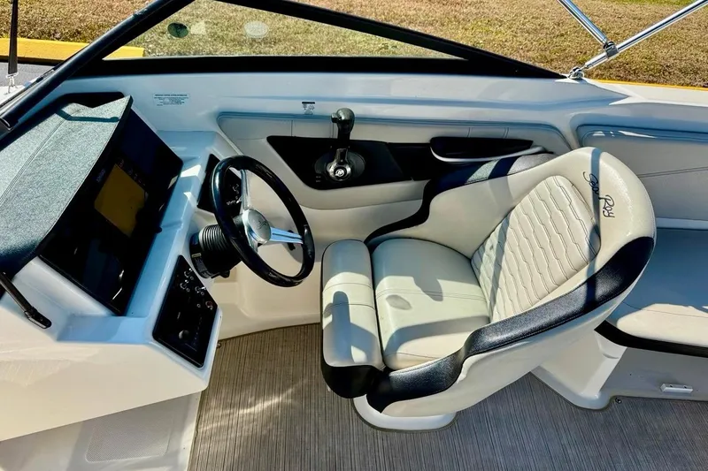 Slide: The Image of 2023 Sea Ray SPX 210 Outboard boat interior with steering wheel and seating. - 14