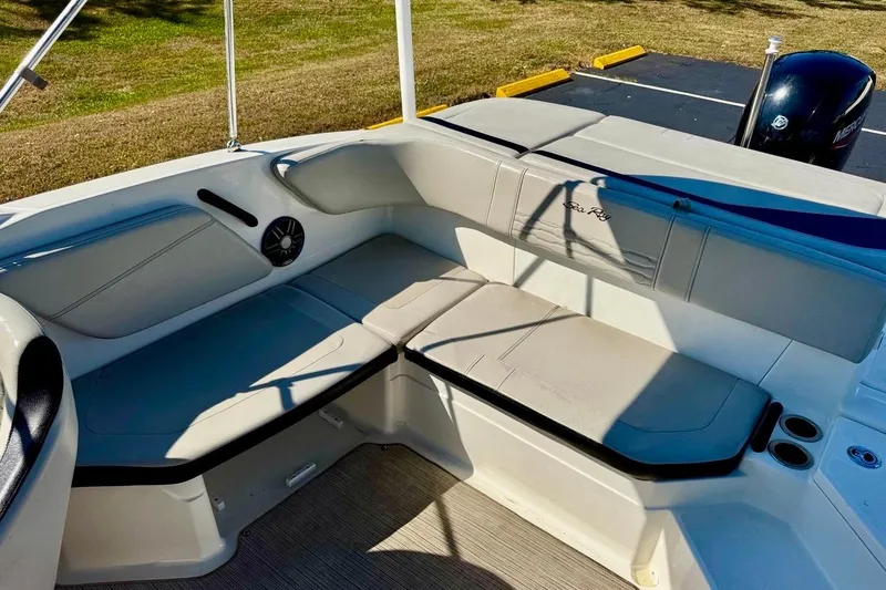 Slide: The Image of 2023 Sea Ray SPX 210 Outboard boat interior with cushioned seating and speaker. - 21