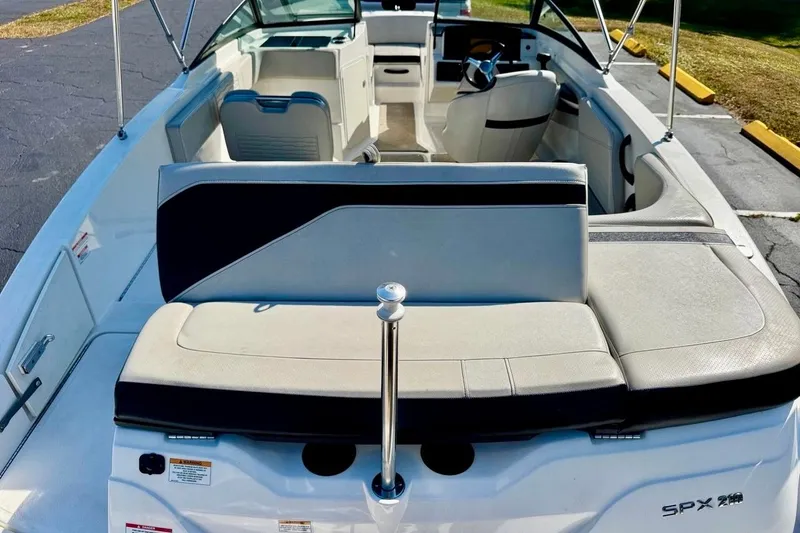 Slide: The Image of 2023 Sea Ray SPX 210 Outboard boat interior with seating and steering wheel. - 23