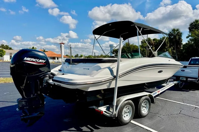 Slide: The Image of 2023 Sea Ray SPX 210 Outboard boat on trailer, featuring Mercury engine, under sunny sky. - 5
