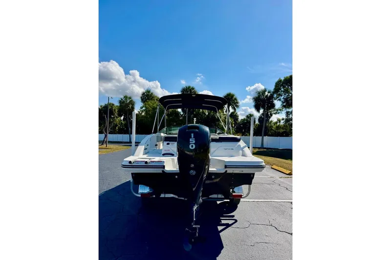 Slide: The Image of 2023 Sea Ray SPX 210 Outboard boat with 150 HP engine, parked outdoors. - 6