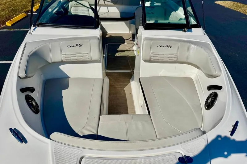 Slide: The Image of 2023 Sea Ray SPX 210 Outboard boat interior with white seating and Sea Ray logo. - 8