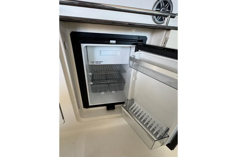 Slide: The Image of 2014 Searay 330 Sundancer boat kitchenette with sink and storage compartment. - 13