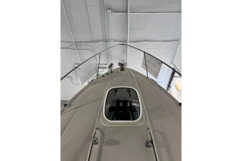 Slide: The Image of 2014 Searay 330 Sundancer boat bow with anchor and railing in a garage setting. - 15