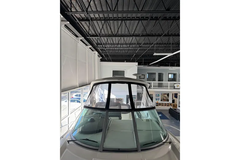 Slide: The Image of 2014 Searay 330 Sundancer interior with kitchenette, bed, and seating area. - 17