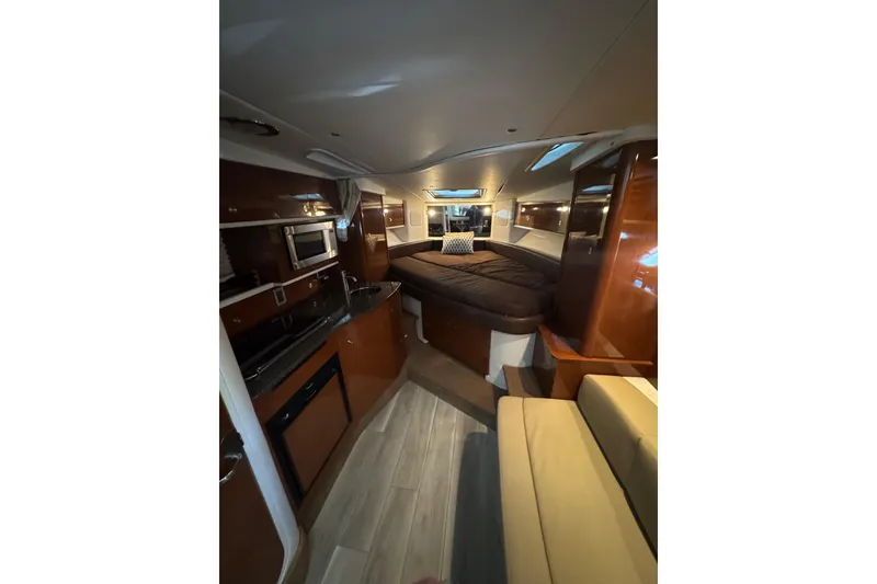 Slide: The Image of 2014 Searay 330 Sundancer yacht interior kitchen with microwave and sink. - 18