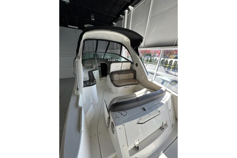 Slide: The Image of 2014 Searay 330 Sundancer boat interior with seating and control panel. - 6