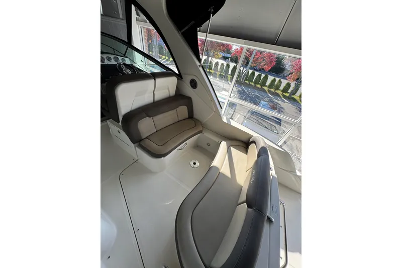 Slide: The Image of Interior of 2014 Searay 330 Sundancer boat with steering wheel and cushioned seating. - 8