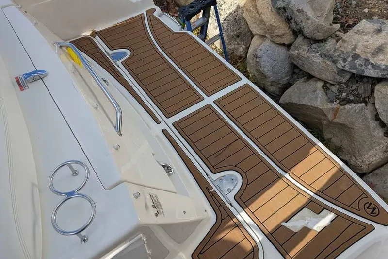 Slide: The Image of 2007 Sea Ray 310 Sundancer swim platform with teak-style decking and stainless steel fittings. - 10