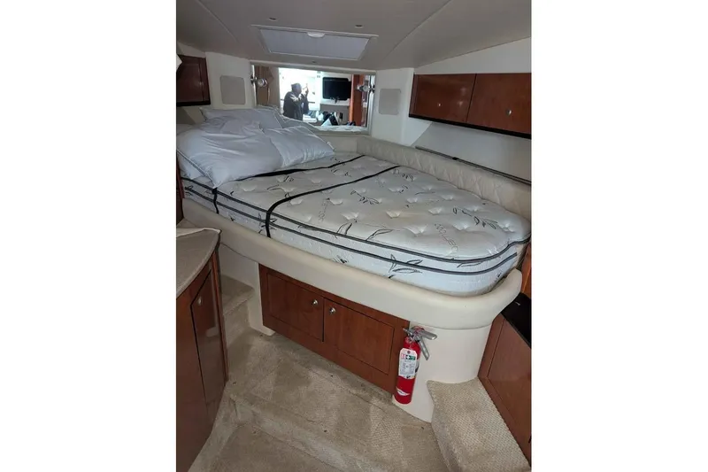 Slide: The Image of 2007 Sea Ray 310 Sundancer cabin interior with bed and storage cabinets. - 13