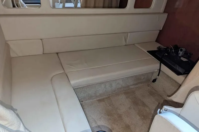 Slide: The Image of Interior cabin of 2007 Sea Ray 310 Sundancer with beige seating and carpet. - 15