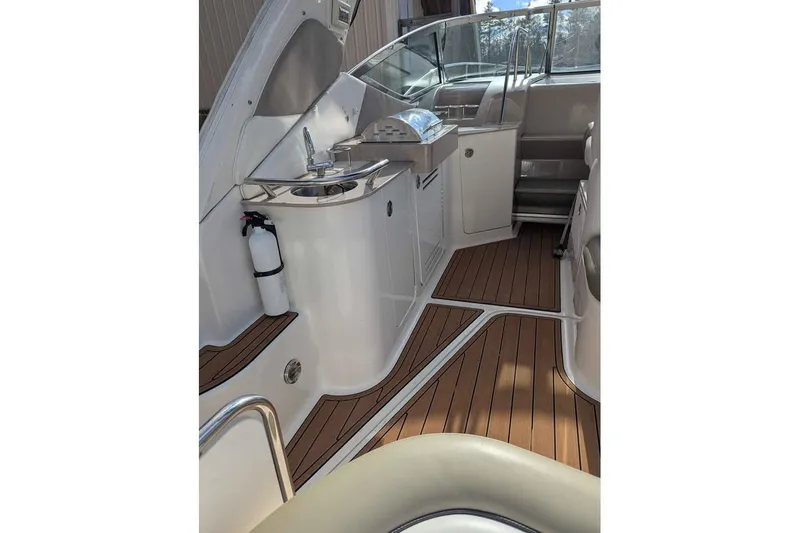 Slide: The Image of 2007 Sea Ray 310 Sundancer interior with wood flooring and compact kitchenette. - 2