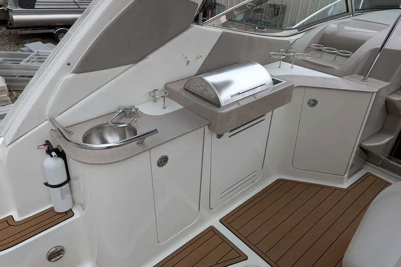 Slide: The Image of 2007 Sea Ray 310 Sundancer boat galley with sink, grill, and storage cabinets. - 3