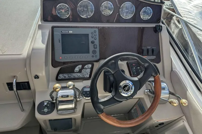 Slide: The Image of 2007 Sea Ray 310 Sundancer helm with steering wheel, gauges, and navigation system. - 4