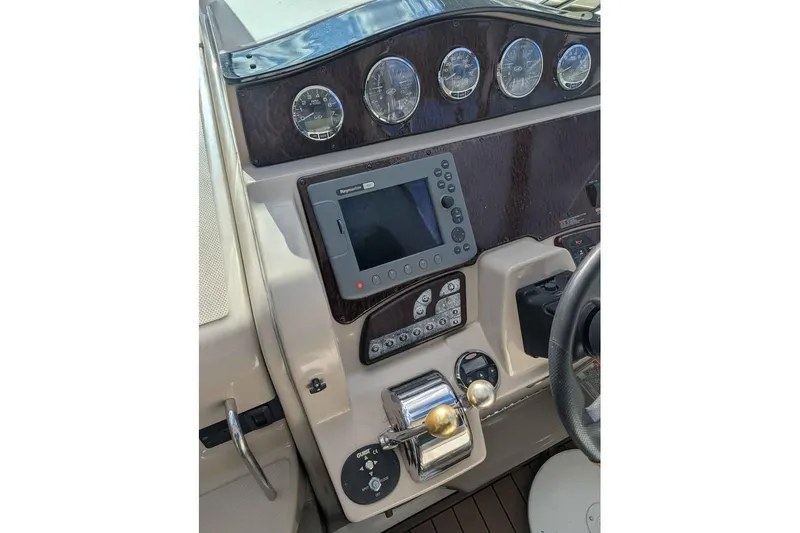 Slide: The Image of 2007 Sea Ray 310 Sundancer dashboard with navigation controls and gauges. - 5