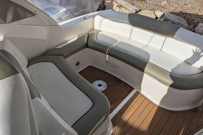 Slide: The Image of 2007 Sea Ray 310 Sundancer boat interior with cushioned seating and wood flooring. - 6