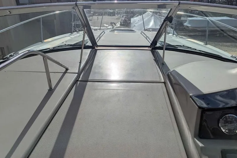 Slide: The Image of 2007 Sea Ray 310 Sundancer boat deck with stainless steel railings and windshield. - 9