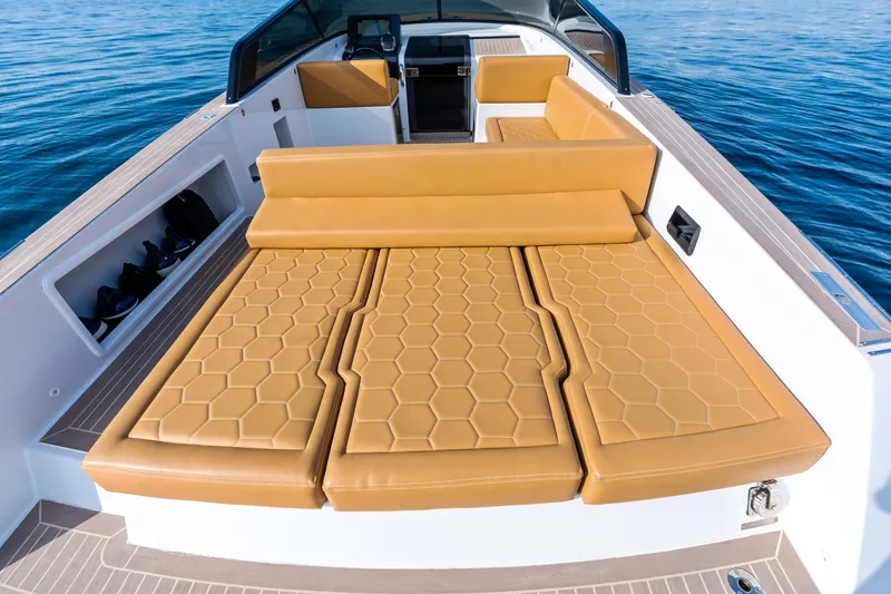 Slide: The Image of Luxurious 2023 VanDutch 32 yacht with tan leather seating and sleek design on open water. - 14