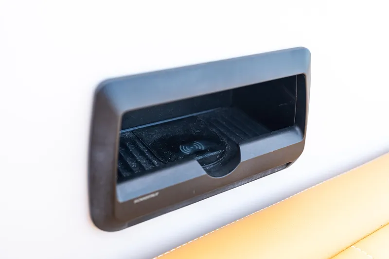 Slide: The Image of VanDutch 32 (2023) wireless charging dock on a sleek boat interior. - 16