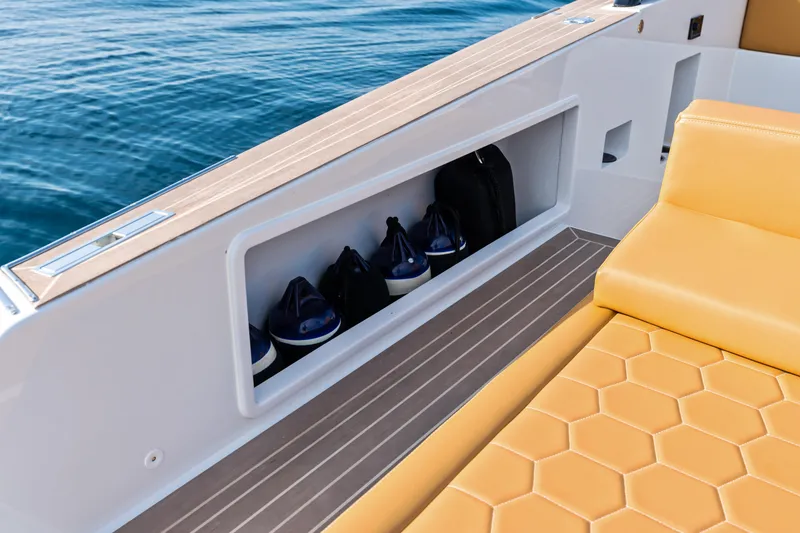 Slide: The Image of 2023 VanDutch 32 yacht interior with honeycomb-patterned seating and storage compartment. - 18