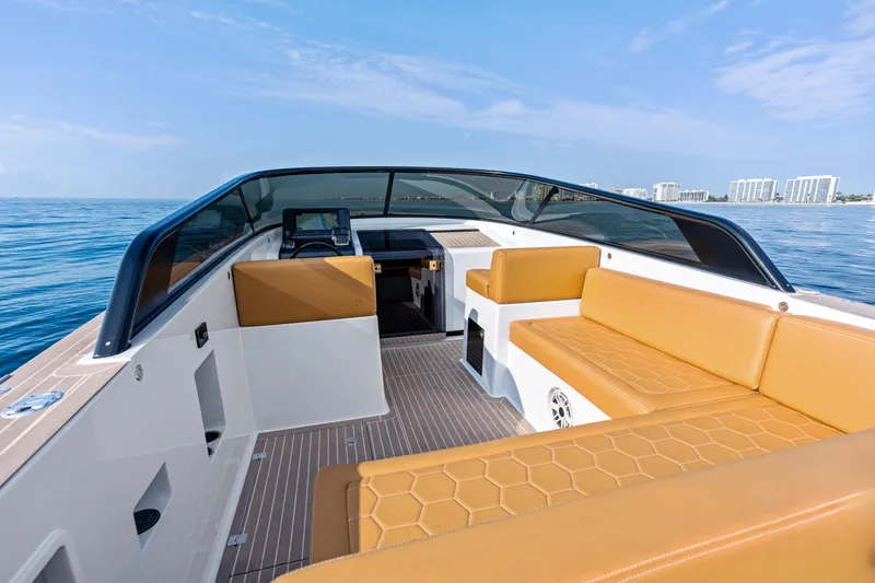 Slide: The Image of 2023 VanDutch 32 yacht interior with tan seating, sleek design, and ocean view. - 20