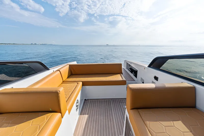 Slide: The Image of Luxury VanDutch 32 yacht interior with tan seating, overlooking serene ocean view. - 24