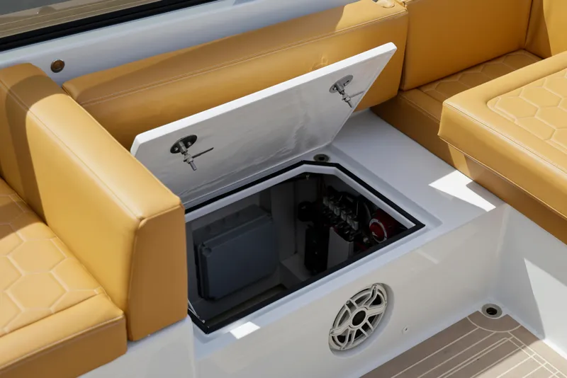 Slide: The Image of 2023 VanDutch 32 boat interior with open storage compartment and tan seating. - 26