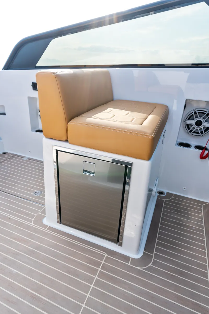 Slide: The Image of 2023 VanDutch 32 boat interior with tan seating and built-in stainless steel storage. - 29