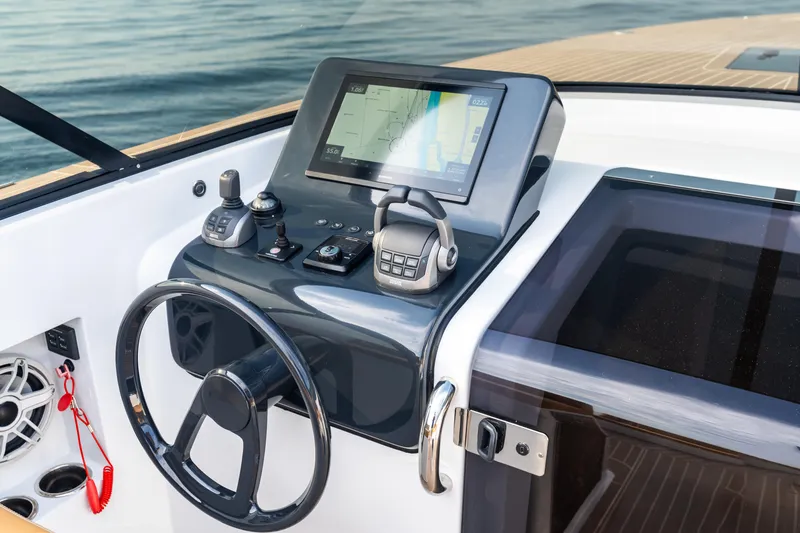 Slide: The Image of 2023 VanDutch 32 yacht helm with modern navigation controls and touchscreen display. - 33