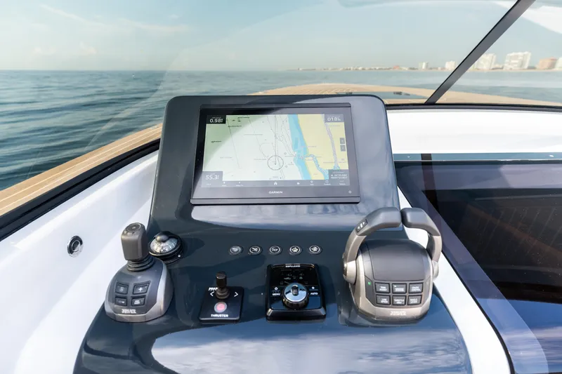 Slide: The Image of Cockpit of 2023 VanDutch 32 yacht with navigation controls and sea view. - 34