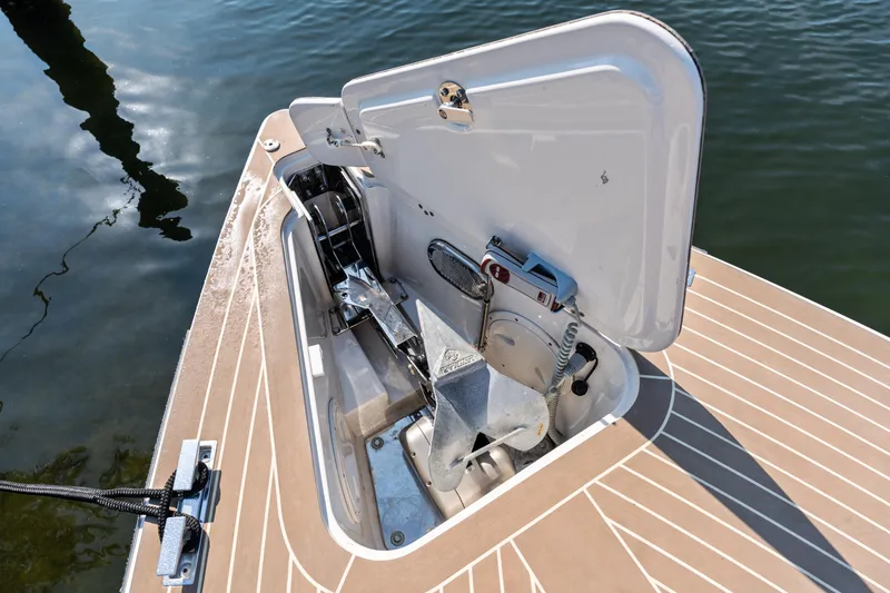 Slide: The Image of Open anchor compartment on 2023 VanDutch 32 boat, showcasing storage and mechanism. - 40